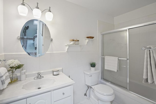 full bathroom with enclosed tub / shower combo, vanity, toilet, and tile walls