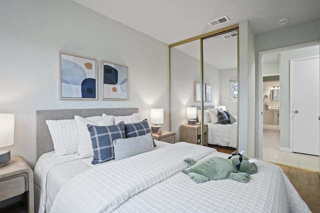 bedroom with wood-type flooring and a closet