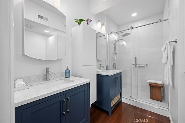 bathroom with vanity, hardwood / wood-style floors, and walk in shower