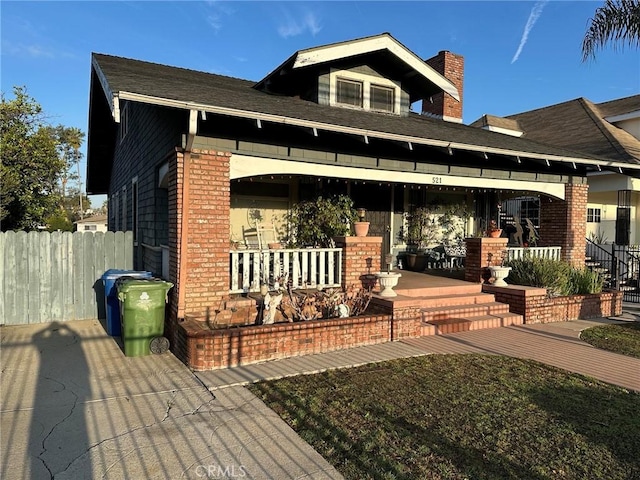 521 S Chicago St, Los Angeles, CA 90033 - view of front of home with a chimney, fence, a porch, and brick siding