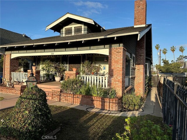 521 S Chicago St, Los Angeles, CA 90033 - view of front of home with brick siding, fence, and a chimney