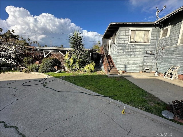 521 S Chicago St, Los Angeles, CA 90033 - view of side of home featuring a patio area, a yard, and stairway