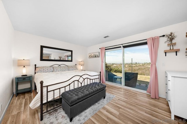 bedroom featuring access to outside and light hardwood / wood-style floors