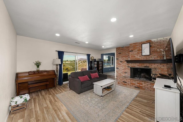 living room featuring a fireplace and light hardwood / wood-style floors