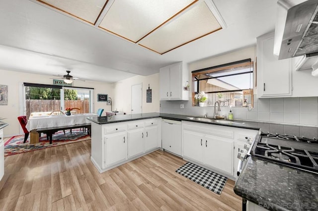 kitchen featuring white cabinetry, white dishwasher, and kitchen peninsula