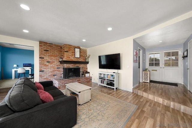 living room with a fireplace and hardwood / wood-style floors