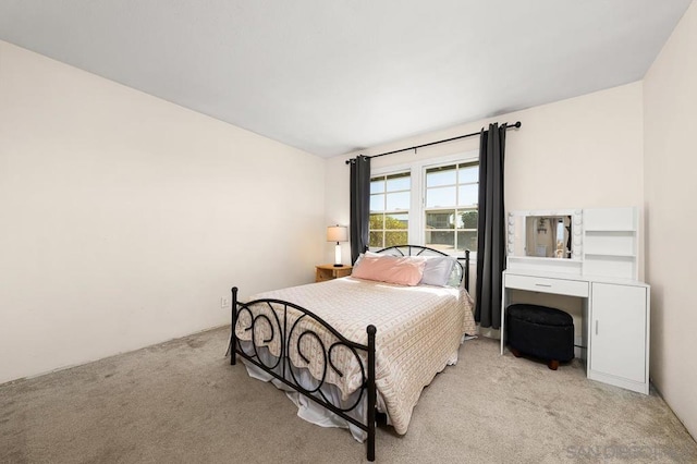 bedroom featuring light carpet