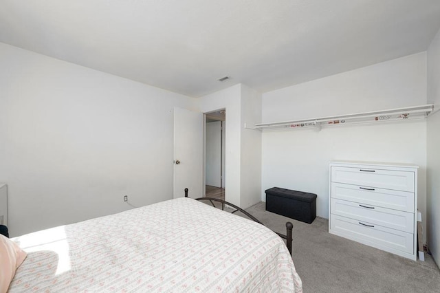 bedroom featuring light colored carpet