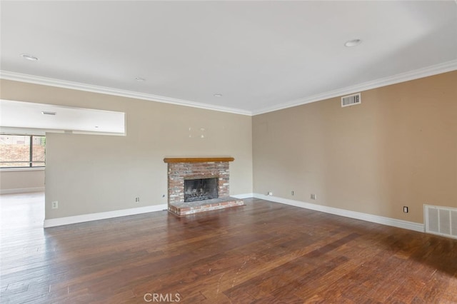 unfurnished living room with hardwood / wood-style flooring, ornamental molding, and a fireplace