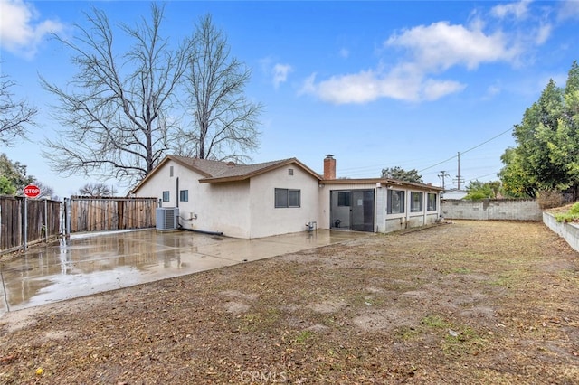 rear view of house featuring a patio area and central air condition unit