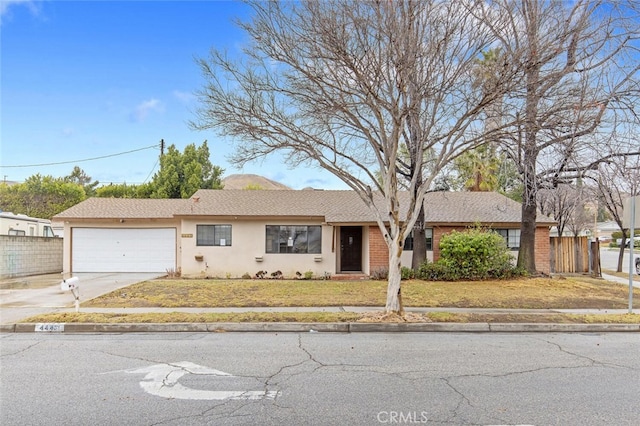 single story home featuring a garage and a front yard