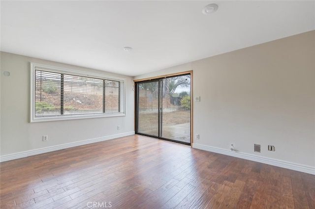 empty room featuring hardwood / wood-style flooring and a healthy amount of sunlight