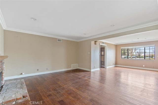 unfurnished living room featuring a brick fireplace, ornamental molding, and hardwood / wood-style floors