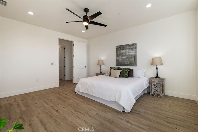 bedroom featuring hardwood / wood-style flooring and ceiling fan