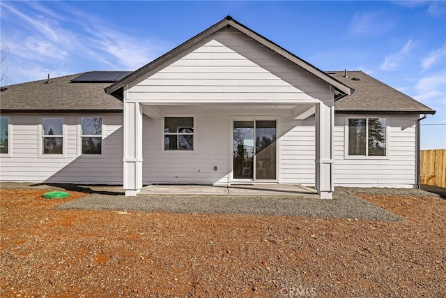 rear view of house with a patio and solar panels