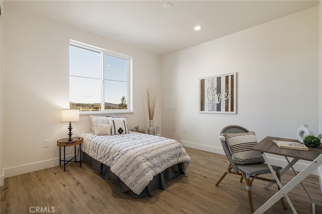 bedroom with hardwood / wood-style floors