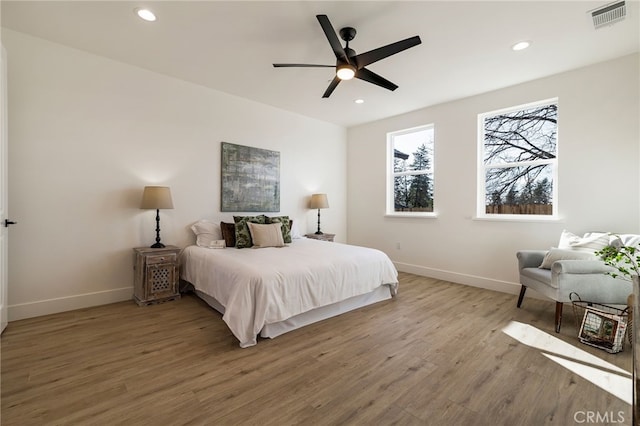 bedroom featuring hardwood / wood-style floors and ceiling fan