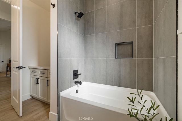 bathroom with wood-type flooring and washtub / shower combination