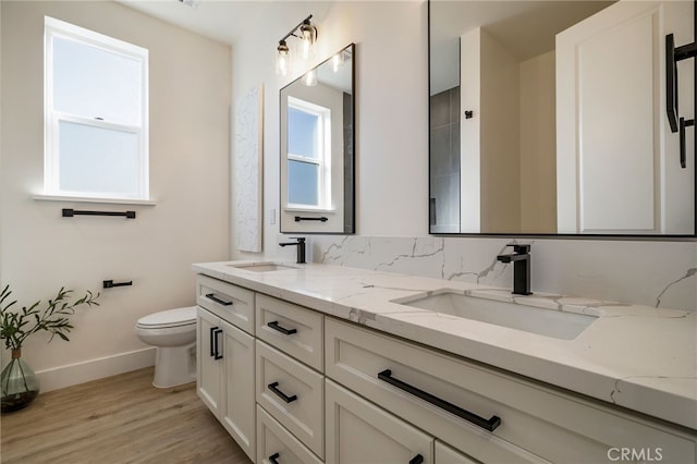 bathroom featuring vanity, hardwood / wood-style flooring, and toilet