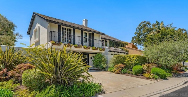 view of front of house featuring a balcony