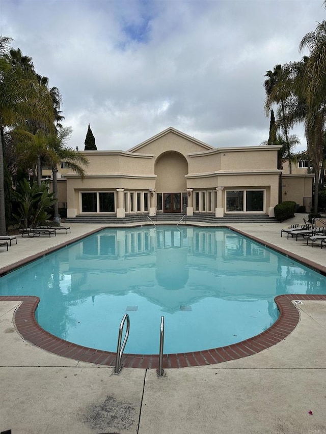 view of swimming pool with a patio