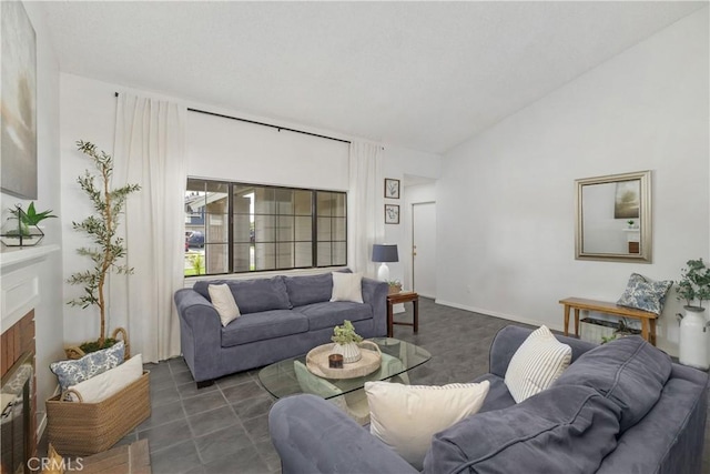 living room featuring vaulted ceiling and a fireplace