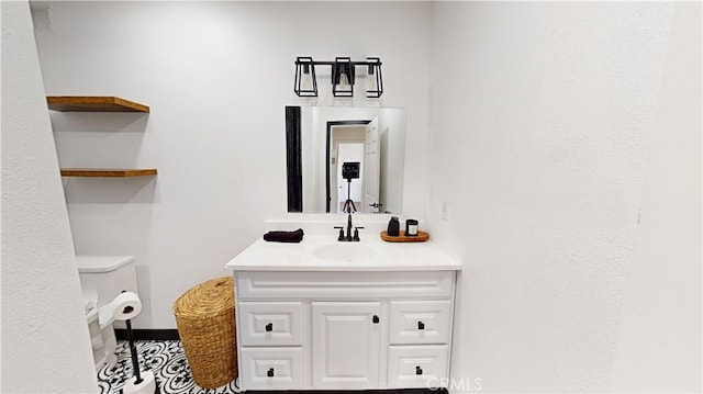 bathroom with vanity and toilet