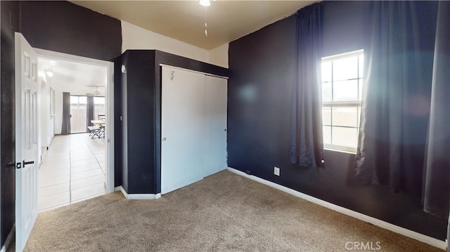 unfurnished bedroom featuring carpet floors and a closet