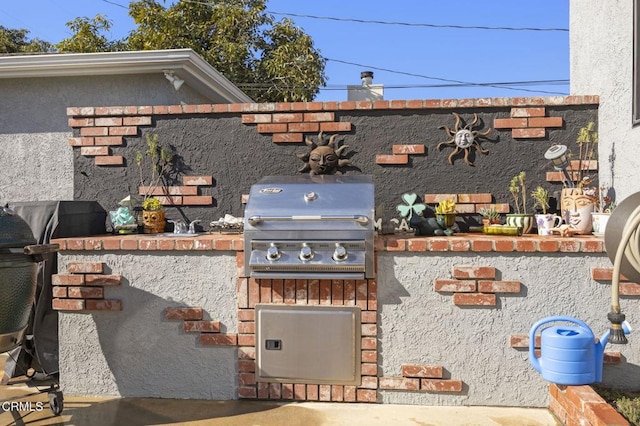 view of patio with grilling area and an outdoor kitchen