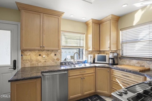 kitchen featuring dishwasher, sink, light brown cabinetry, and a healthy amount of sunlight