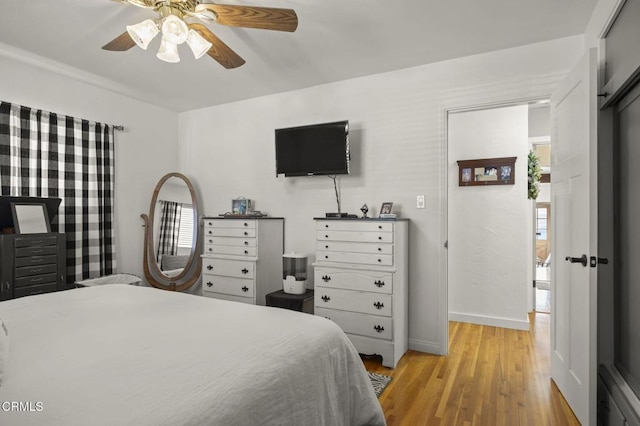 bedroom with ceiling fan and light wood-type flooring