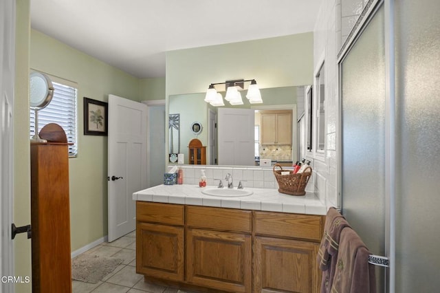 bathroom featuring vanity, tile patterned floors, and decorative backsplash