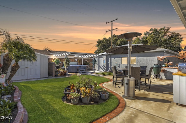 yard at dusk with a patio area and a pergola