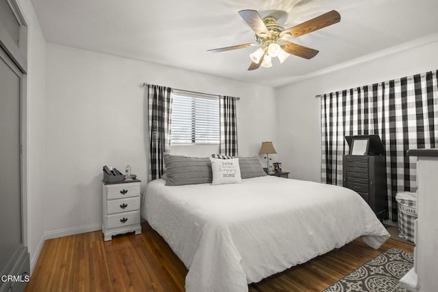 bedroom with dark wood-type flooring and ceiling fan