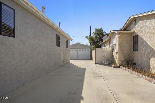 view of property exterior featuring an outbuilding and a garage