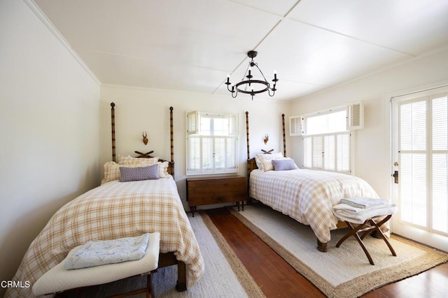 bedroom with multiple windows, ornamental molding, dark hardwood / wood-style floors, and an inviting chandelier