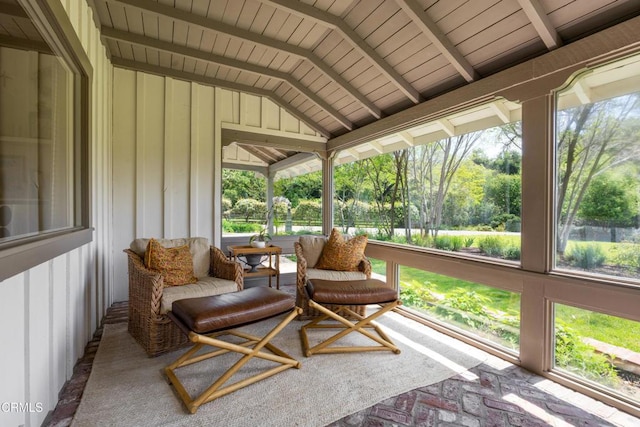 sunroom with vaulted ceiling with beams