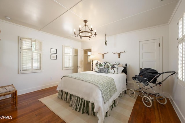 bedroom featuring a notable chandelier, crown molding, and dark hardwood / wood-style floors