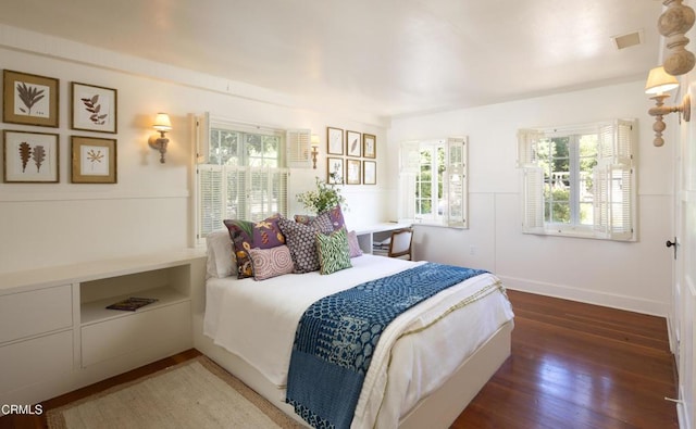 bedroom with dark wood-type flooring