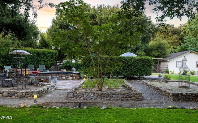 yard at dusk with a patio