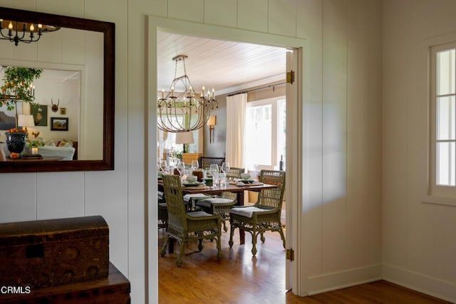 dining space with a notable chandelier and hardwood / wood-style flooring