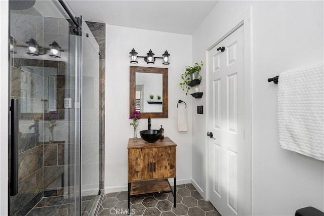 bathroom featuring tile patterned floors, vanity, and a shower with door