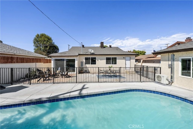 view of swimming pool with ac unit and a patio area