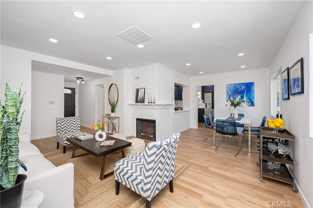 living room featuring a fireplace and light hardwood / wood-style flooring