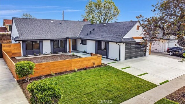 view of front of property featuring a garage and a front yard