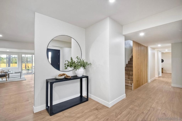 corridor with light hardwood / wood-style floors