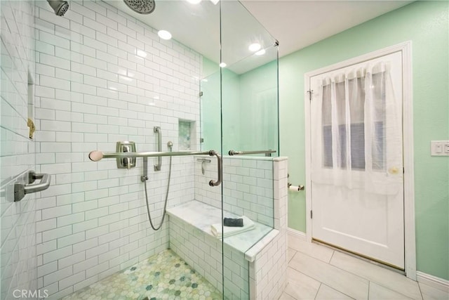 bathroom featuring an enclosed shower and tile patterned flooring