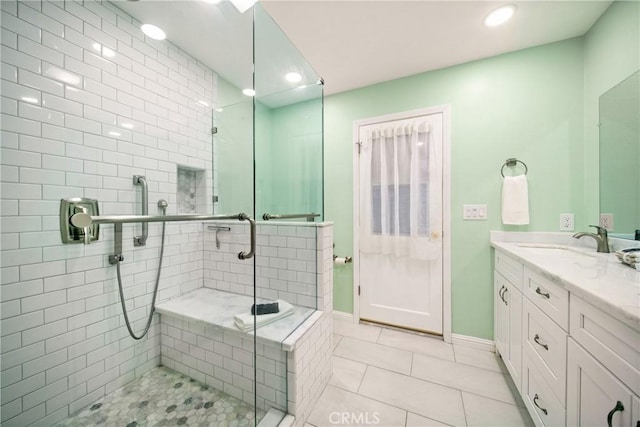 bathroom featuring vanity, a shower with shower door, and tile patterned floors