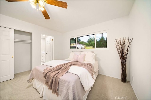 bedroom featuring light carpet, a closet, and ceiling fan