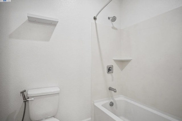 bathroom with shower / washtub combination and toilet